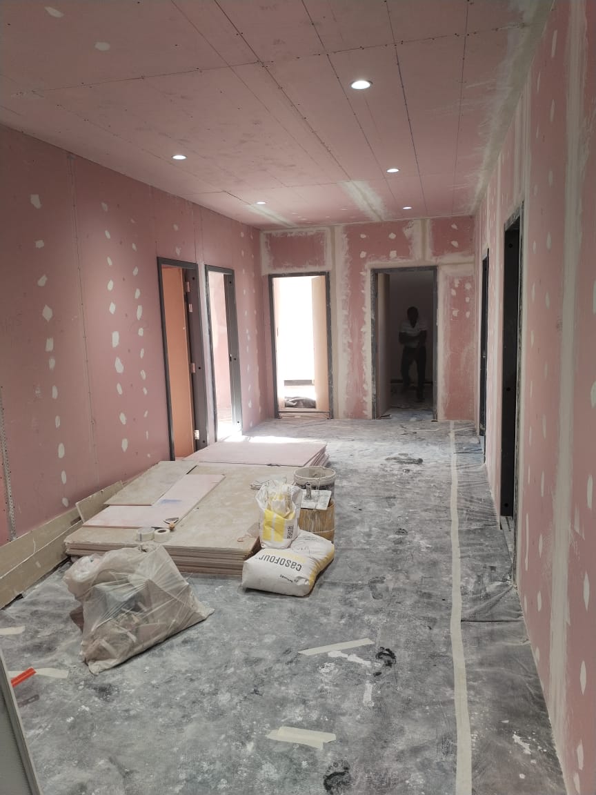 Drywall being installed on site